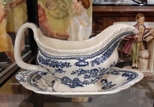Antique gravy boat on a stand