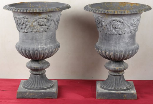 A pair of cast iron flowerpots