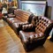 A pair of Chesterfield armchairs and a sofa