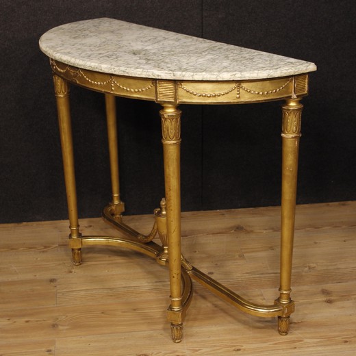 Furniture in nicely carved and gilded woodand plaster in Louis XVI style. Elegant neoclassical console table with original marble top in perfect condition.