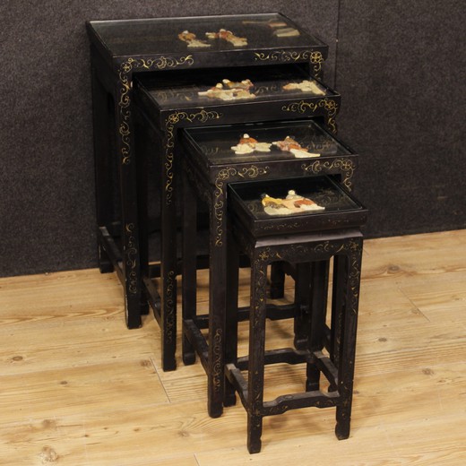 Set of French side tables from the 20th century. Beautiful furniture in lacquered and painted wood with soap stone decorations. Set consisting of four tables with glass tops, of a fair size and service.Side tables ideal to be inserted in a living room but