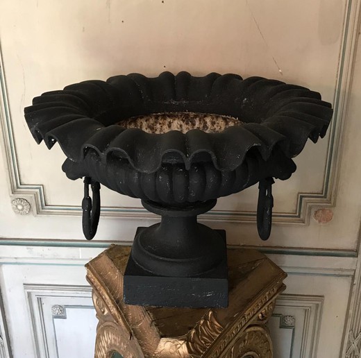 pair of cast iron garden urns two lion heads holding a ring in the mouth.