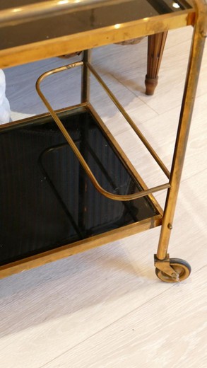 Charming rolling bar forming serving. Brass and trays in black glass. Casters allow the set to be moved.