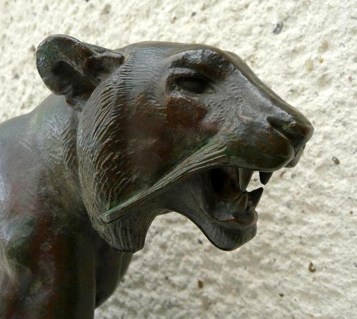 Antique sculpture of a walking tiger