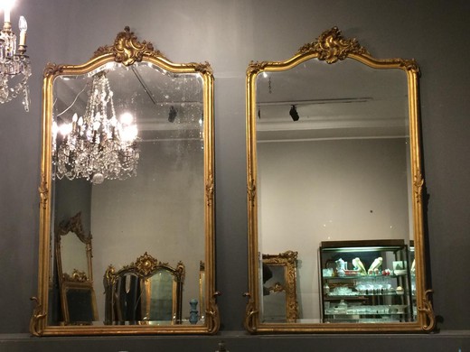 Antique pair mirrors in the style of Louis XV. The frames are made of gilded wood. France, XIX century.
