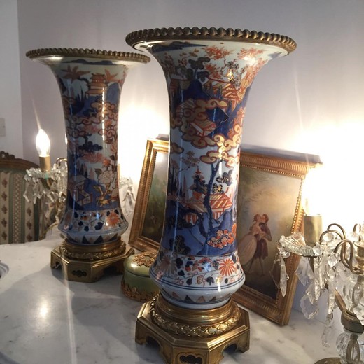 Ancient pair vases in oriental style. Made of porcelain. Decorated with elements of gilded bronze. Imari, Japan, XIX century.