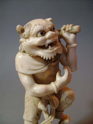 An antique okimono with the image "Oni". It is made of bone. France, 1900s.
