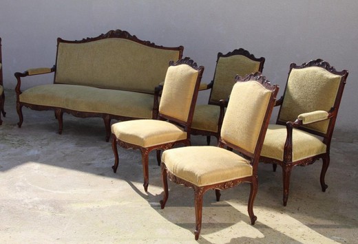 Antique set in the style of Louis XV. Seth includes a sofa, two wide armchairs and a pair of chairs. Made of walnut. France, XIX century.