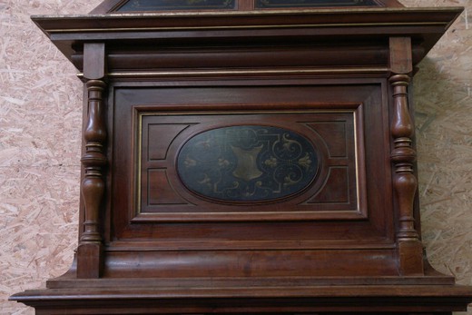 Antique fireplace portal. Made of walnut. Decorated with paintings. Europe, the XIX century.