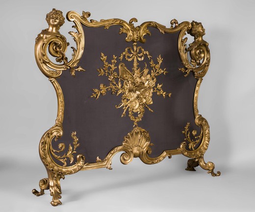 Antique fireplace screen in the style of Louis XV. It is made of gilded bronze. France, 1900s.
This magnificent fireplace screen is decorated with "Linka style" ornaments that combined the style of the Regency and the style of Louis XV in the era of Ar N