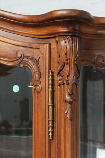 Antique showcase in the style of Louis XV. It is made of walnut. France, the 20th century.