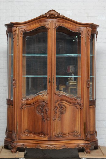 Antique showcase in the style of Louis XV. It is made of walnut. France, the 20th century.