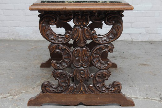 Antique coffee table in the Renaissance style. Made of oak. The table top is marble. France, the 20th century.