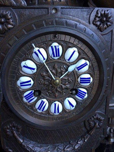 Ancient clock in the style of Louis XV. Made of metal. The basis is a tree. France, the end of the XIX century.