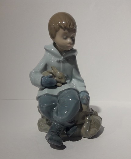 Antique sculpture of a boy with a rabbit