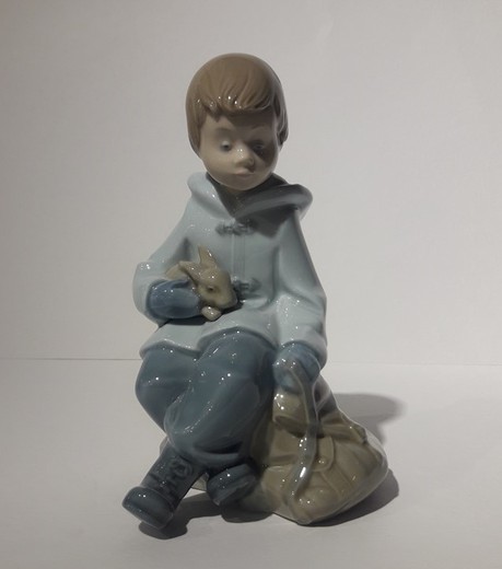 Antique sculpture of a boy with a rabbit