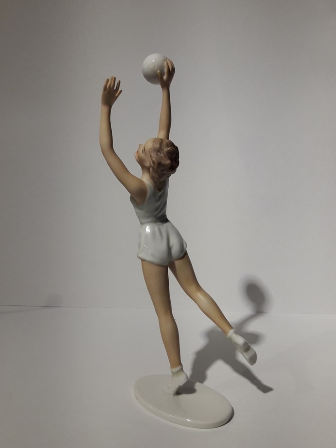 Antique sculpture of a volley ball player