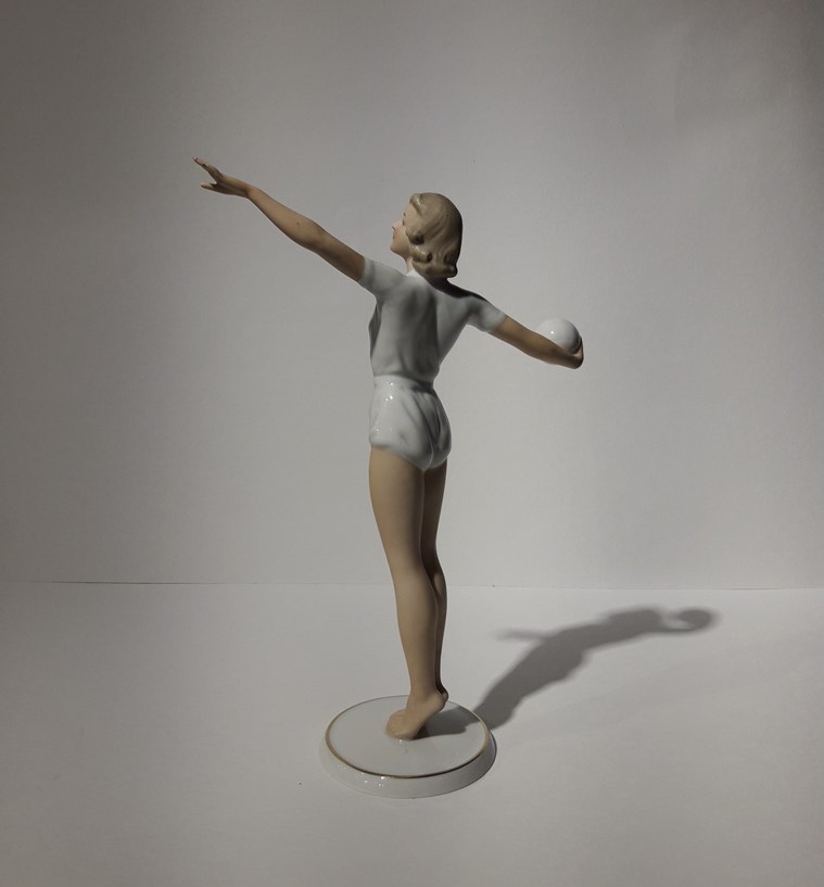 Antique sculpture of a volley ball player
