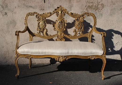 Antique bench in the style of Louis XV. It is made of wood. France, the 20th century.