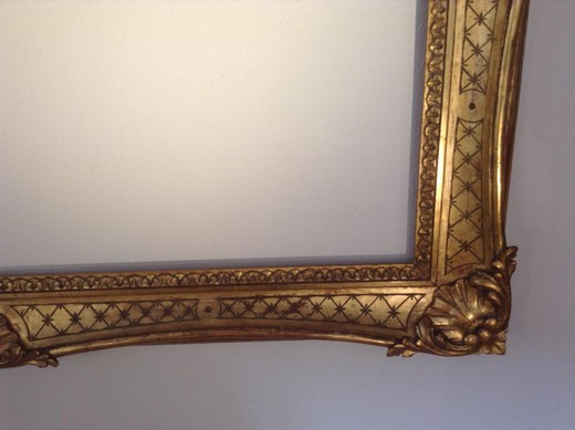 Antique frame in the style of Louis XV. It is made of wood with gilding. France, XIX century.