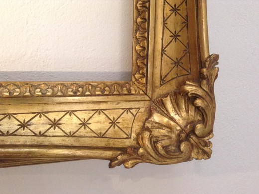 Antique frame in the style of Louis XV. It is made of wood with gilding. France, XIX century.