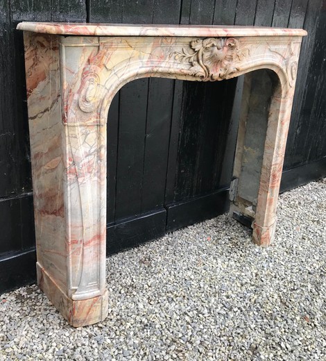 Antique fireplace portal in the style of Louis XV. It is made of marble Sarrankolin. France, XIX century.