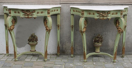 Antique pairing consoles in the style of Napoleon III. Made of wood. Decorated with patches of bronze. The worktops are marble. France, XIX century.