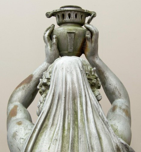 Antique garden sculpture "Girl with a jug". It is made of metal. Europe, the twentieth century.