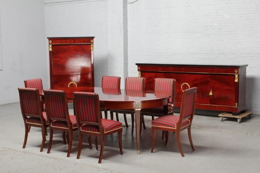 Antique dining room (dresser, bar, table, eight chairs) in Empire style. It is made of mahogany. Decorated with patches of gilded bronze. Europe, the twentieth century.