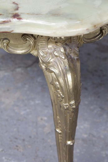 A vintage coffee table in the style of Louis XV. It is made of gilded bronze. The worktop is onyx. Italy, 1950's.