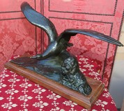 Antique sculpture of a seagull on a wave