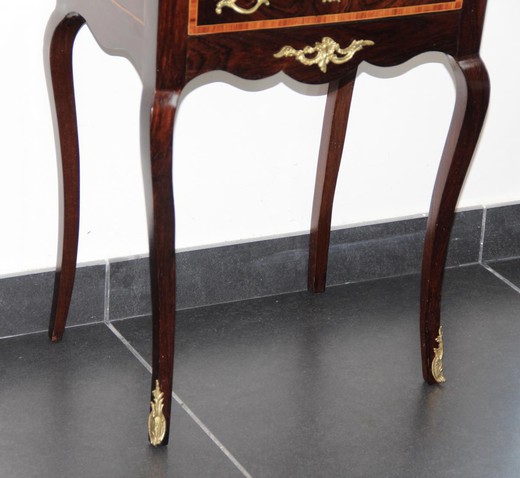 An antique ladies' table in the style of Napoleon III. It is made of rosewood. Decorated with patches of gilded bronze. France, XIX century.