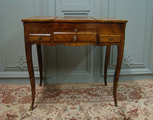 Antique dressing table in the style of Louis XV. Made of wood in marquetry. France, XIX century.