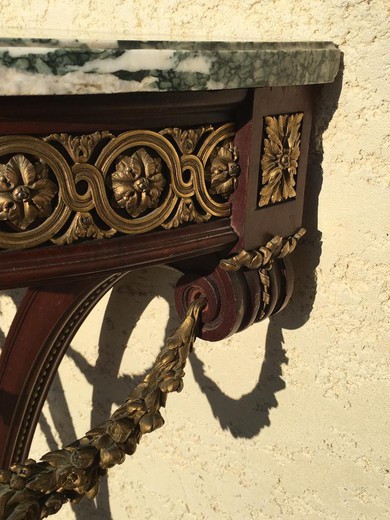 Antique console in the style of Louis XVI. Made of solid mahogany. Decorated with patches of gilded bronze. Table top made of gray marble "Saint Anne". France, XIX century.