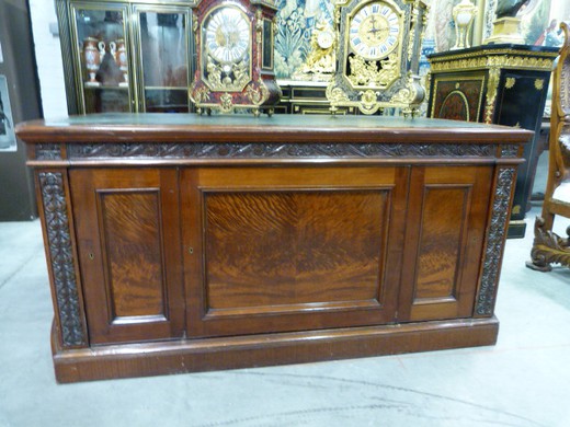 Antique desk in American style. Made of Cuban mahogany. The worktop is covered with green skin. Europe, the XIX century.