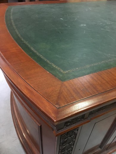 Antique desk in American style. Made of Cuban mahogany. The worktop is covered with green skin. Europe, the XIX century.