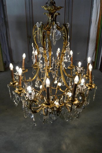 Large antique chandelier in the style of Louis XV. It is made of gilded bronze and crystal. France. XIX century.