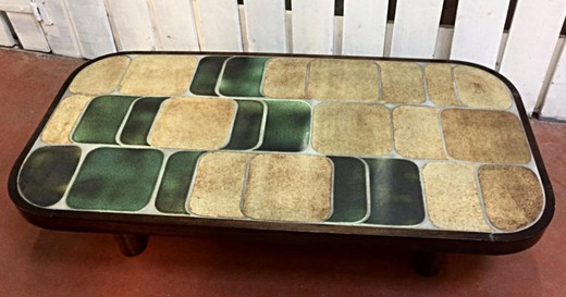 A vintage coffee table in the style of Mid-Sentury modern. It is made of wood. Table top - ceramics. The work of the famous French ceramist - Roger Capron. France, the 20th century.