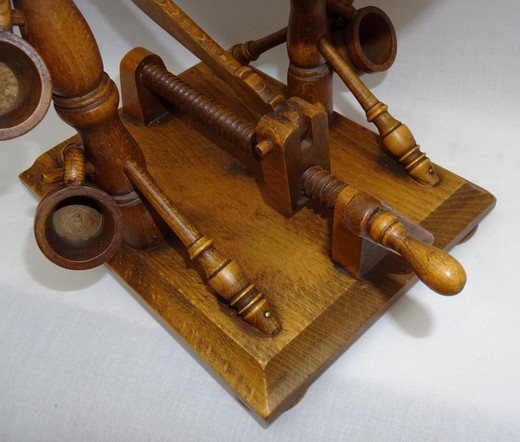 Antique mechanical bottle holder. It is made of wood. The slope of the bottle is adjustable. In a set of six wooden wine glasses. France, the 20th century.