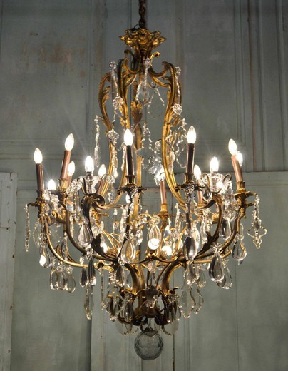 Large antique chandelier in the style of Louis XV. It is made of gilded bronze and crystal. France. XIX century.