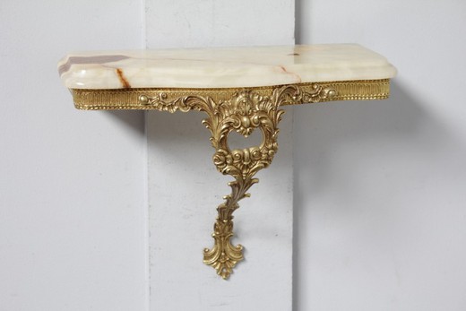 Antique console with a mirror in the style of Louis XV. It is made of gilded bronze. The console top is onyx. France, the middle of XX century.