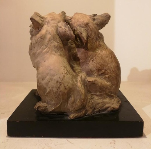 Antique sculpture of two dogs in love