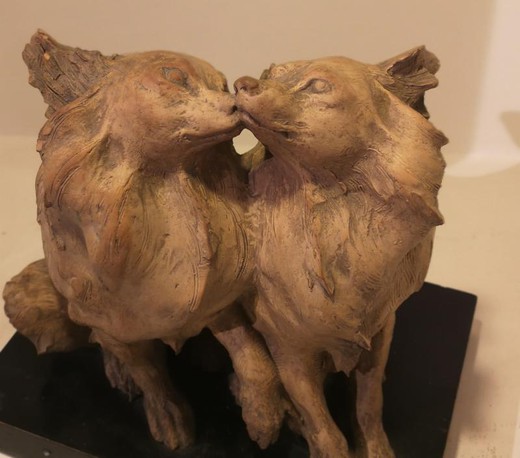 Antique sculpture of two dogs in love