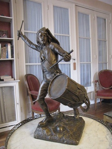 Antique bronze sculpture of a young guy with the drum