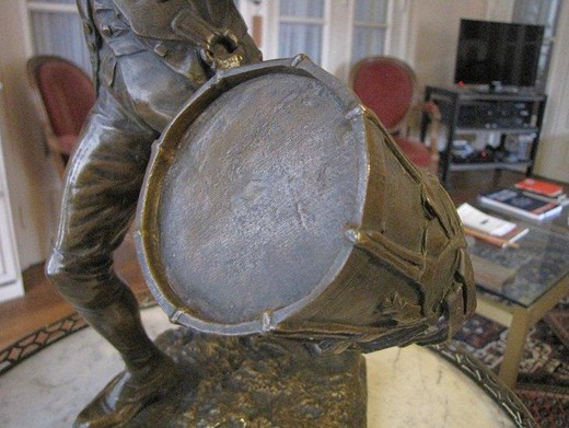 Antique bronze sculpture of a young guy with the drum
