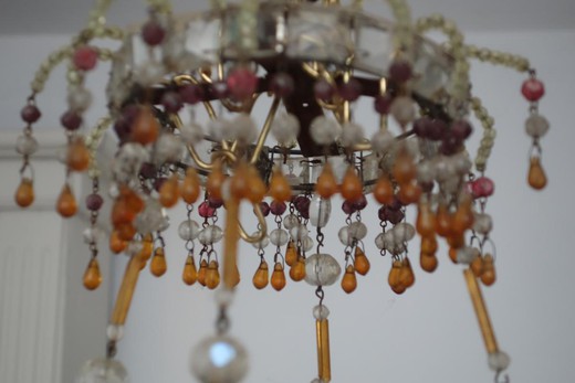 an antique chandelier in the style of Charles X, an antique chandelier with pearls, an antique bronze chandelier, an antique glass chandelier, an antique gallery, an antique shop, an antiquarian light, an antiques shop