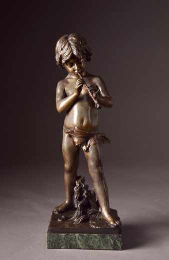 antique sculpture boy with a pipe