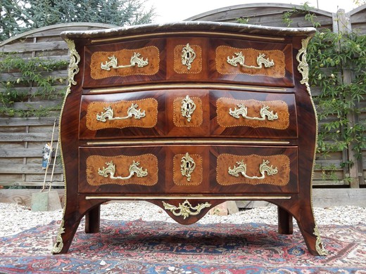 an antique chest of drawers made of wood with marble,