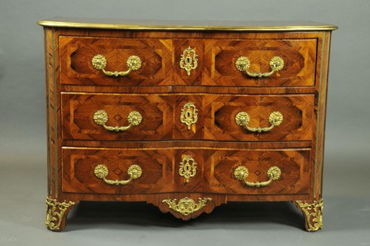 an antique chest of drawers made of wood and bronze