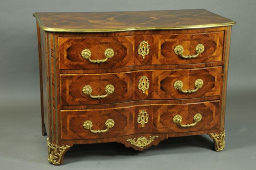 an antique chest of drawers made of wood and bronze